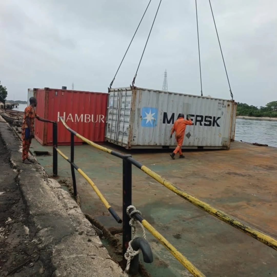 Maersk and Hamburg Sud containers being loaded at dock