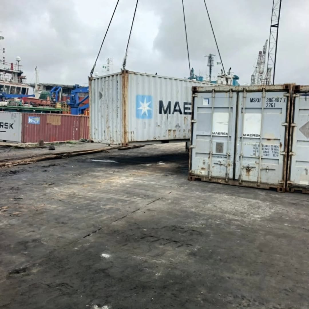 Maersk containers at busy port yard with cranes